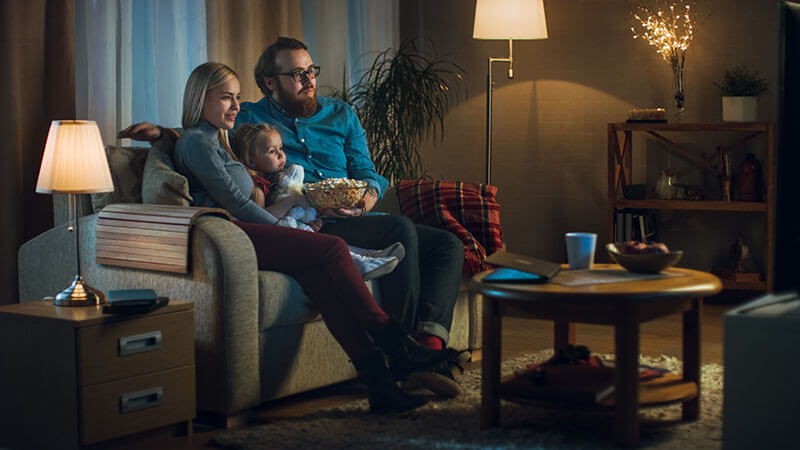 family watching tv in air conditioned home.